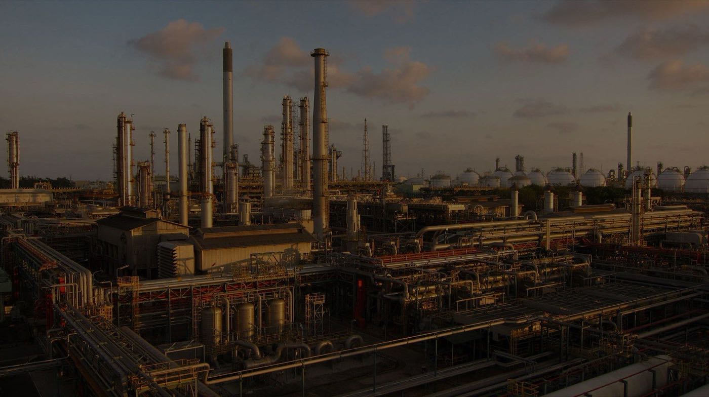 Industrial plant at dusk coated and maintained by Allen Blasting and Coating